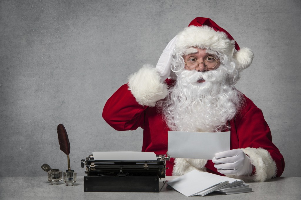 Santa Claus typing a letter on an old typewriter